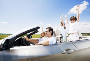 Traveling family driving in the Convertible car.